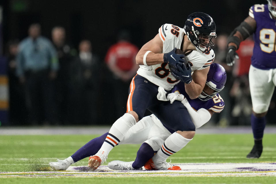 Chicago Bears tight end Cole Kmet (85) is tackled by Minnesota Vikings safety Camryn Bynum (24) after catching a pass during the first half of an NFL football game, Monday, Nov. 27, 2023, in Minneapolis. (AP Photo/Abbie Parr)