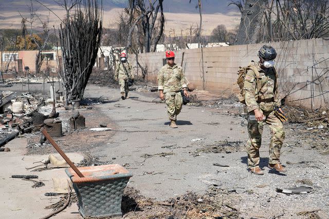 <p>Andrew Jackson/Us Air/Planet Pix via ZUMA Press Wire</p> Hawaii Army National Guard Search and Rescue soldiers patrol neighborhoods of burnt out homes in the aftermath of wildfires that destroyed most of Lahaina town,