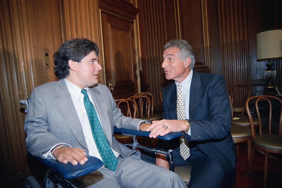 FILE - In this June 28, 1989, file photo, Marc Buoniconti, left, and his father, former Miami Dolphins player Nick Buoniconti, speak after Marc received the American Institute for Public Service Jefferson Award at the Supreme Court in Washington. Pro Football Hall of Famer Ed Reed and such sports stars as Dwyane Wade, Wladimir Klitschko, Chase Utley, Matt Biondi, Christian Vieri, Amy Van Dyken-Rouen and Meghan Duggan will be honored by The Buoniconti Fund to Cure Paralysis on Monday night, Oct. 7, 2019, at the organization’s annual gala. The night really will be dedicated to the late Nick Buoniconti. (AP Photo/J. Scott Applewhite, FIle)