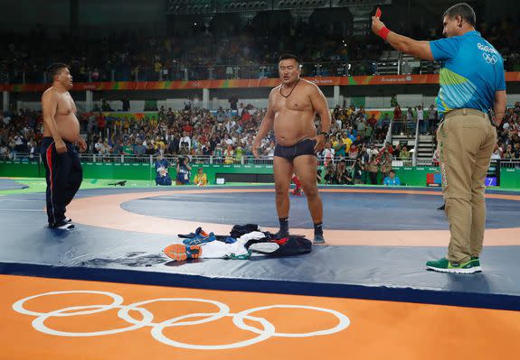 TOPSHOT - Mongolia's Mandakhnaran Ganzorig's coaches react after the judges announced that Uzbekistan's Ikhtiyor Navruzov won following a video replay in their men's 65kg freestyle bronze medal match on August 21, 2016, during the wrestling event of the Rio 2016 Olympic Games at the Carioca Arena 2 in Rio de Janeiro. / AFP / Jack GUEZ        (Photo credit should read JACK GUEZ/AFP/Getty Images)