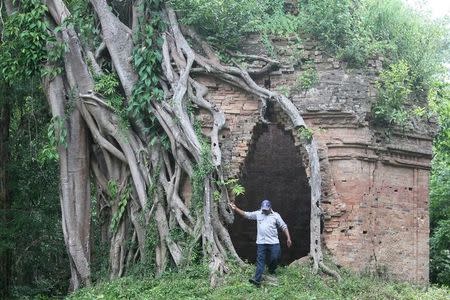 A man walks at Sambor Prei Kuk, or "the temple in the richness of the forest" an archaeological site of ancient Ishanapura, after it was listed as a UNESCO world heritage site, in Kampong Thom province, Cambodia July 15, 2017. Picture taken July 15, 2017. REUTERS/Samrang Pring