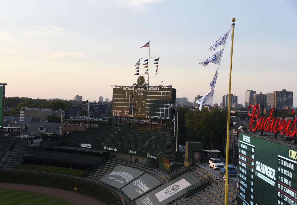 Empty seats are viewed during the sixth inning of an opening day baseball game between the Chicago Cubs and the Milwaukee Brewers, Friday, July, 24, 2020, in Chicago. (AP Photo/David Banks)