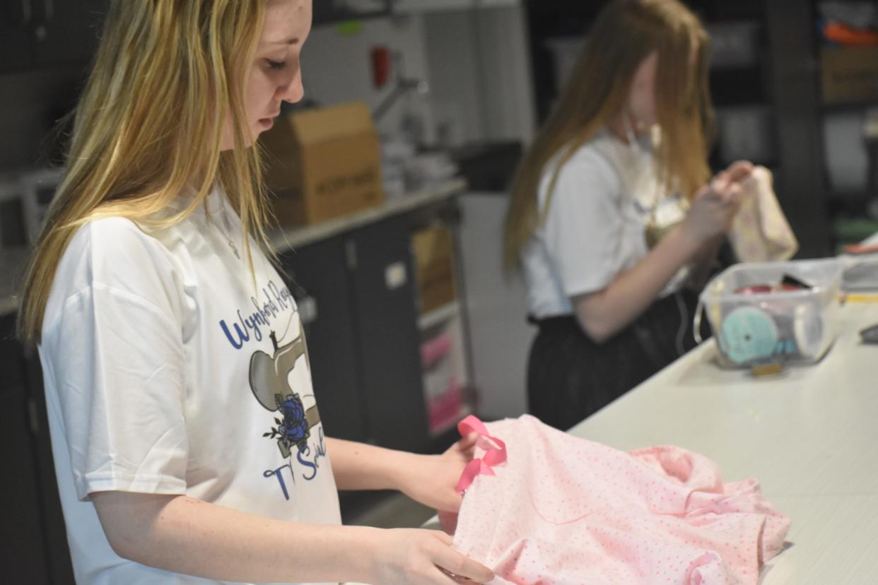Emma Goldy, 14, puts the finishing touches on a pair of pink shorts.