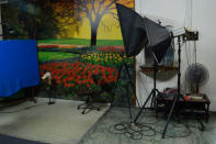 Inside the studio, a surreal mural depicts a countryside scene sets the mood for clients who want wedding photos.