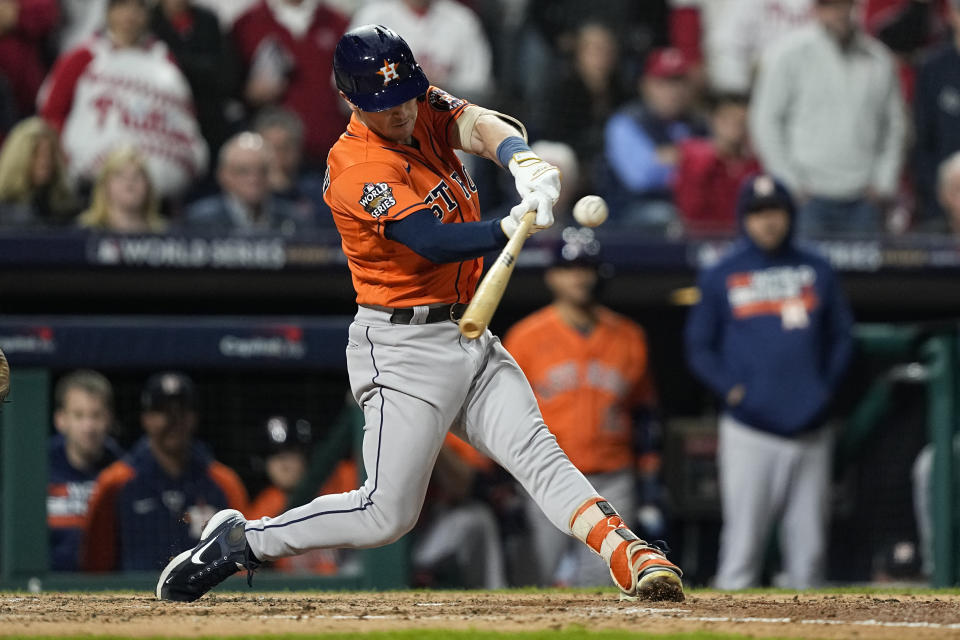 Houston Astros' Alex Bregman hits a two-RBI double during the fifth inning in Game 4 of baseball's World Series between the Houston Astros and the Philadelphia Phillies on Wednesday, Nov. 2, 2022, in Philadelphia. (AP Photo/David J. Phillip)