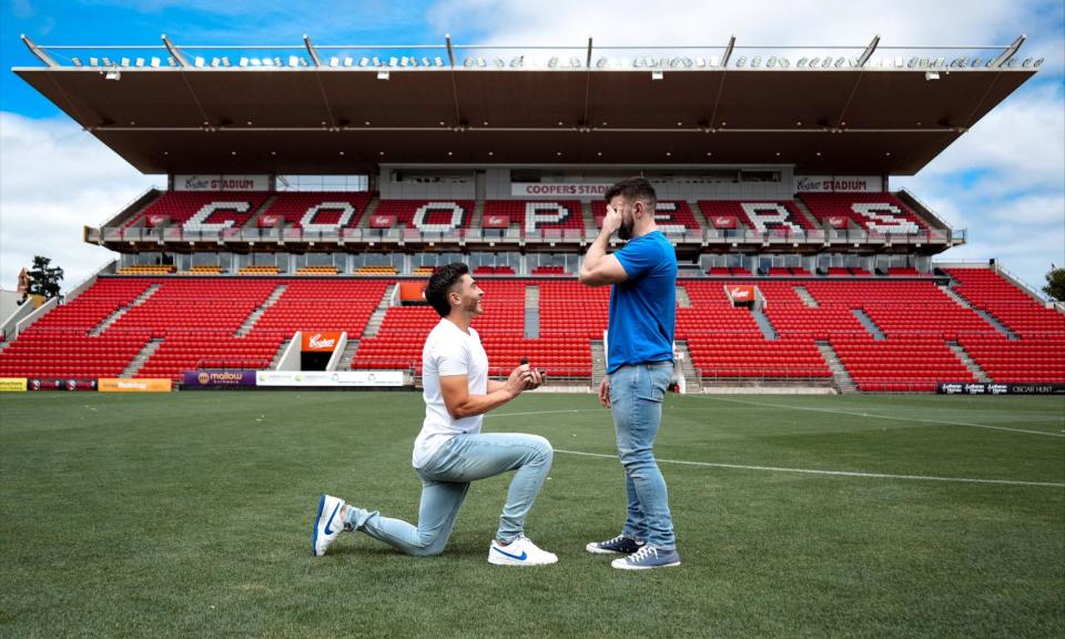 <span>Josh Cavallo proposes to his partner at Adelaide United's Coopers Stadium.</span><span>Photograph: Courtney Pedlar/Reuters</span>