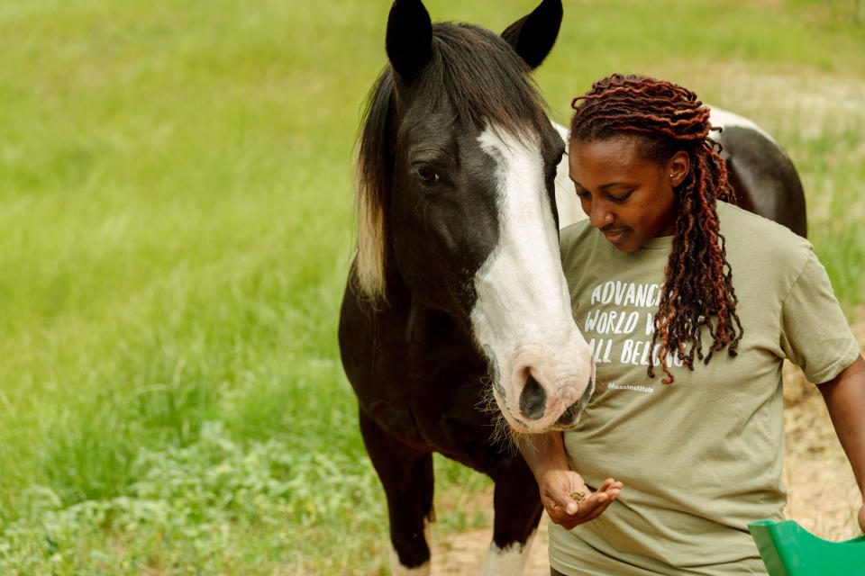 Keisha feeds her horse, Hercules, who helped inspire her to create the farm. (Photo: Lynsey Weatherspoon for HuffPost)