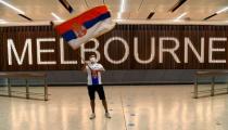 A Serbian tennis fan waves a flag as he awaits Novak Djokovic in Melbourne on January 6, 2022, shortly before Australian officials cancelled the tennis star's entry visa (AFP/William WEST)