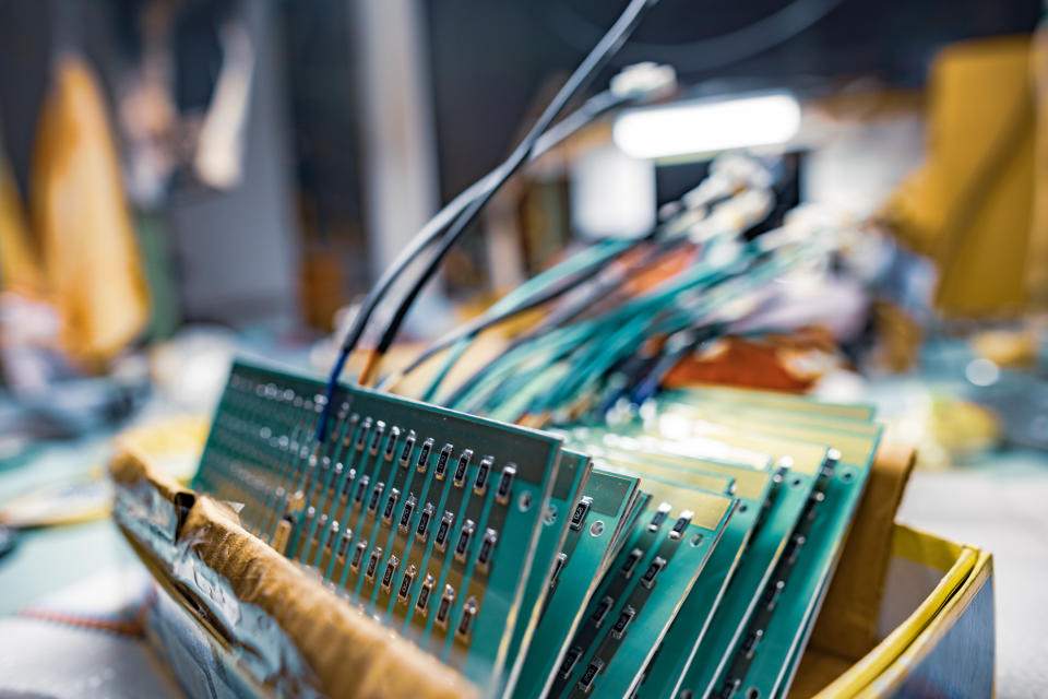 Set of chips on microcircuit board for contemporary TFT displays in cardboard box in plant assembling workshop extreme closeup