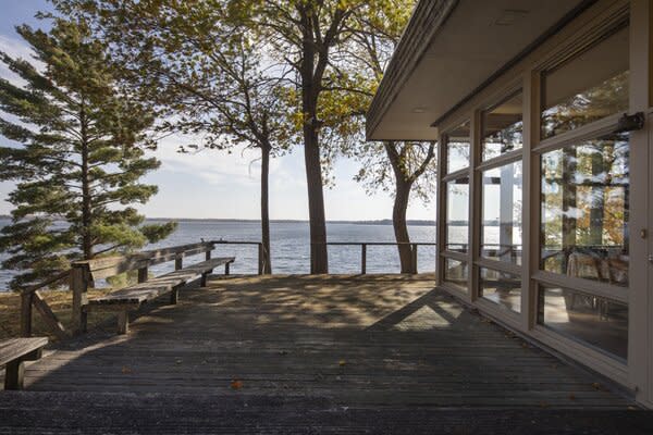 The living areas open to a spacious deck with waterfront views.