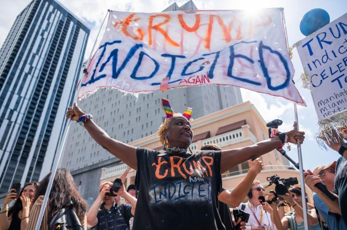 June 13, 2023: Nadine Seiler shouts and holds a sign reading &quot;Trump Indicted&quot; while standing outside the Wilkie D. Ferguson Jr. Courthouse on Tuesday, June 13, 2023, in Miami, Fla. Former President Donald Trump was scheduled to appear in federal court to be arraigned Tuesday afternoon, facing charges that he illegally retained national security documents after leaving office.