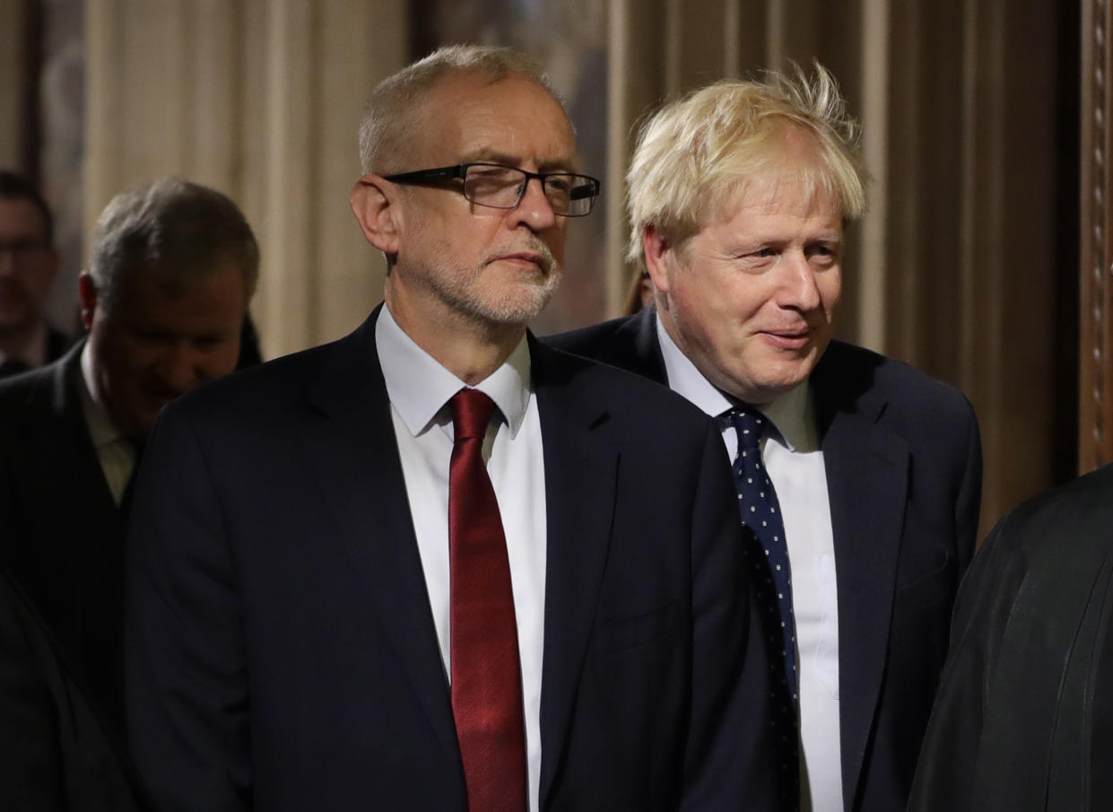 Britain's Prime Minister Boris Johnson, right, and opposition Labour Party Leader Jeremy Corbyn, left, walk through the Commons Members Lobby in Parliament, London, Monday, Oct. 14, 2019. Britain's parliament returns from a brief break for the State Opening of Parliament. (AP Photo/Kirsty Wigglesworth, pool)