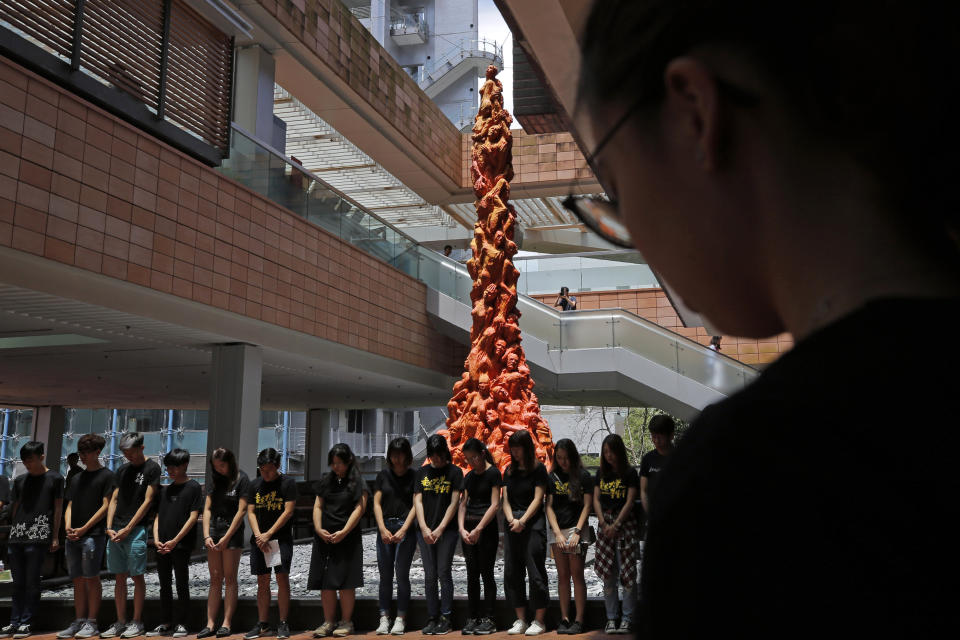 FILE - In this June 4, 2019, file photo, university students clean the "Pillar of Shame" statue, a memorial for those killed in the 1989 Tiananmen crackdown, at the University of Hong Kong. Danish artist Jens Galschioet is seeking to get back his sculpture in Hong Kong memorializing the victims of China's 1989 Tiananmen Square crackdown as a deadline loomed for its removal Wednesday, Oct. 13, 2021. (AP Photo/Kin Cheung, File)