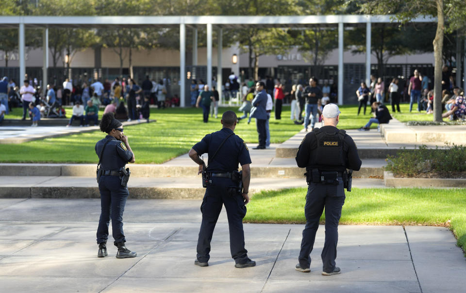 Houston Police officers watch over displaced churchgoers outside Lakewood Church, Sunday, Feb. 11, 2024, in Houston, after a reported shooting during a Spanish church service. (Karen Warren/Houston Chronicle via AP)