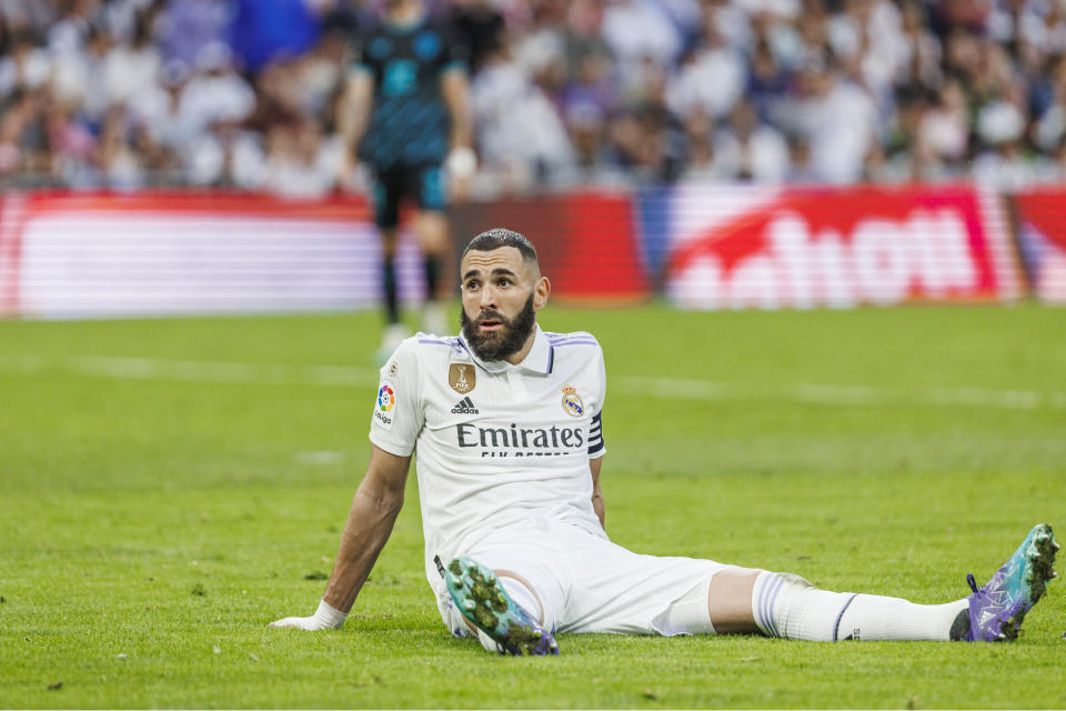 FILE - Real Madrid's Karim Benzema sits on the pitch during a Spanish La Liga soccer match between Real Madrid and Almeria at the Santiago Bernabeu stadium in Madrid, Spain, Saturday, April 29, 2023. The most feared striker in Europe won’t be playing at the European Championship. That’s because Erling Haaland’s Norway didn’t qualify. Other big names missing from the Euros include Karim Benzema, Marcus Rashford, Mats Hummels and Sandro Tonali. (AP Photo/Pablo Garcia, File)