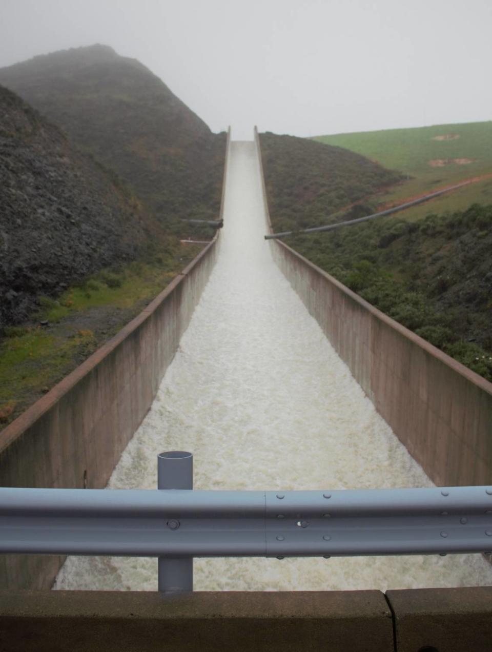 Water spills from a full Whale Rock Reservoir near Cayucos on Saturday, March 11, 2023, for the first time in about 18 years after heavy winter rainstorms.
