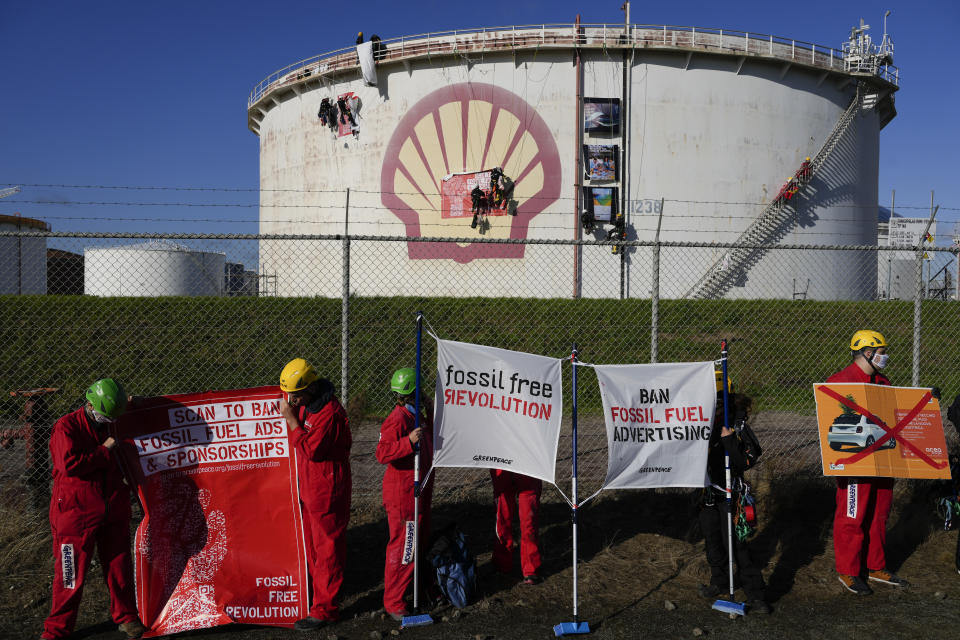 Greenpeace climate activists stage a protest at a Shell refinery in Rotterdam, Netherlands, Monday, Oct. 4, 2021. A coalition of environmental groups launched a campaign calling for a Europe-wide ban on fossil fuel advertising ahead of the United Nations Climate Change Conference, also known as COP26, which start in Glasgow on Oct. 31st, 2021. (AP Photo/Peter Dejong)