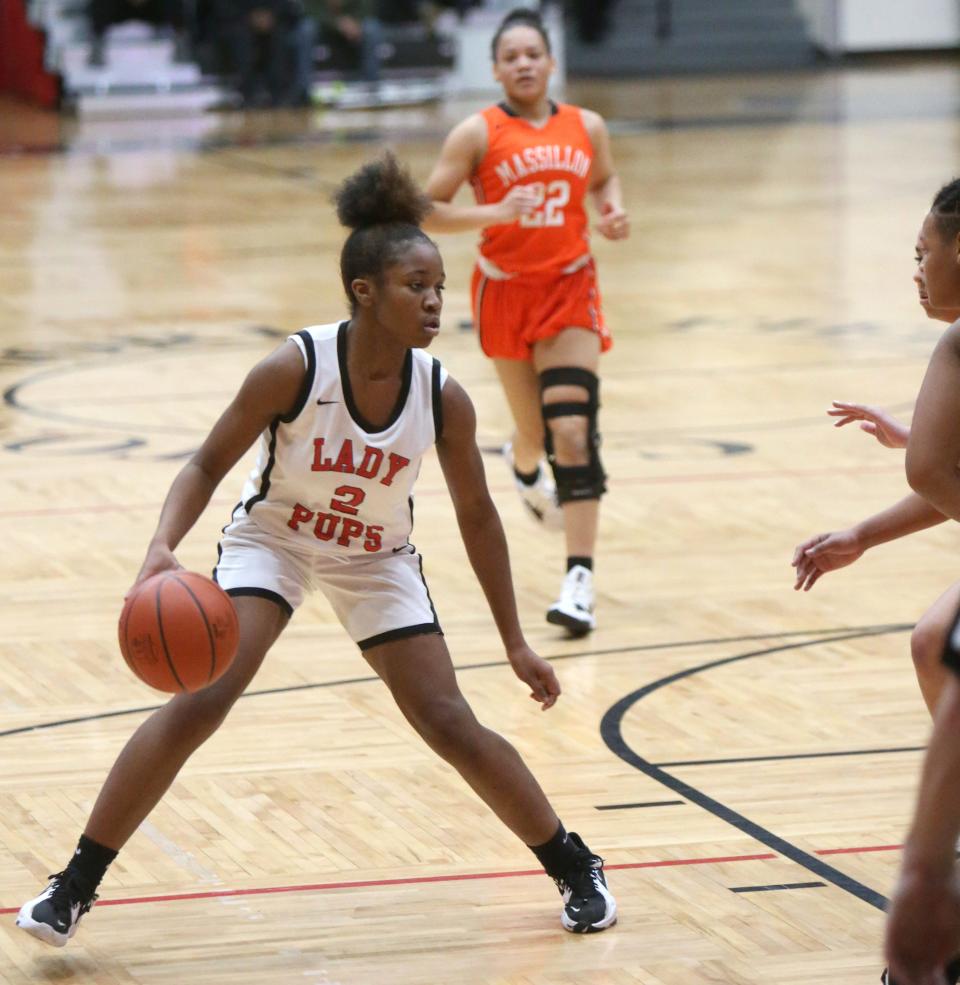 Paris Stokes, 2, of McKinley looks for an opening during their game against Massillon at McKinley on Monday, Jan. 31, 2022. Visible for the Tigers is Kaliyah Hewitt, rear.