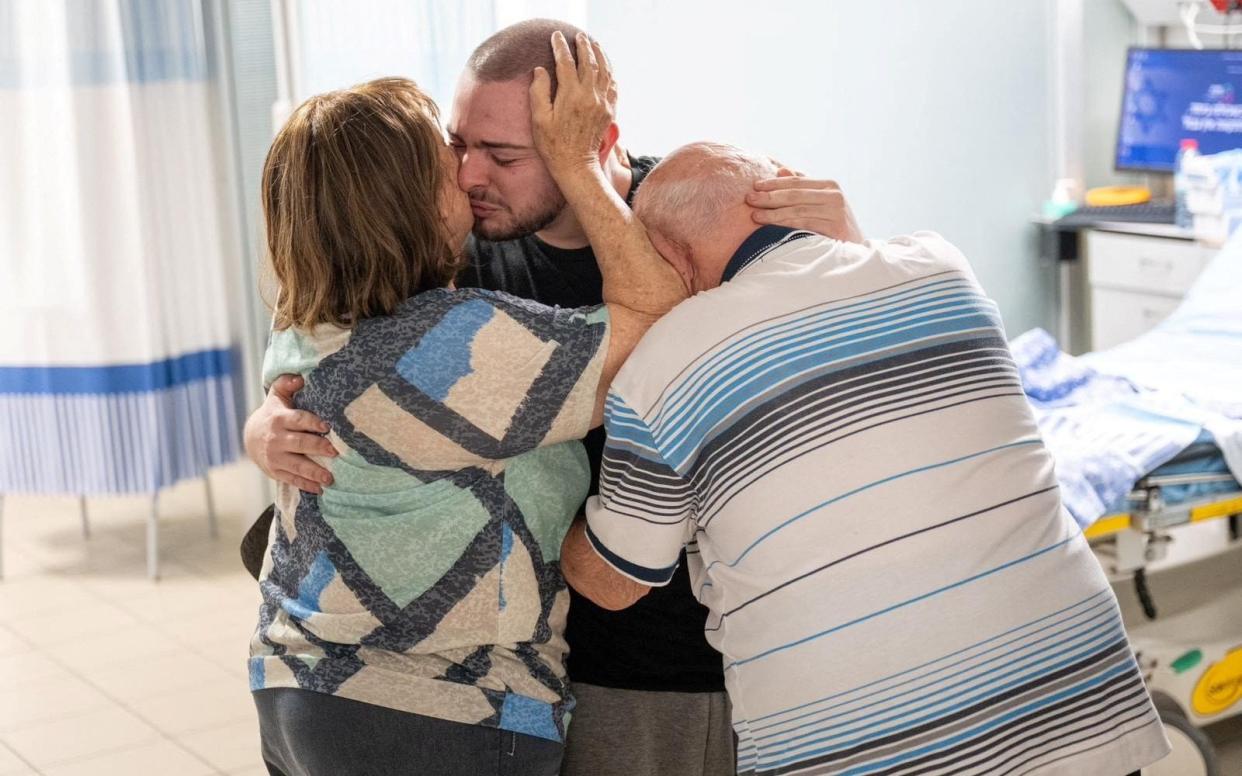 Almog Meir Jan, 21, is pictured reuniting with his family