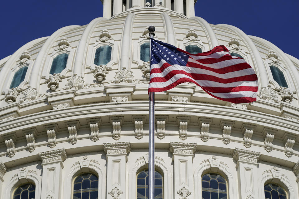 FILE - An American flag waves below the U.S. Capitol dome on Capitol Hill in Washington, June 9, 2022. Only in the mid-20th century was a federal code established for how the flag should be handled and displayed. (AP Photo/Patrick Semansky, File)