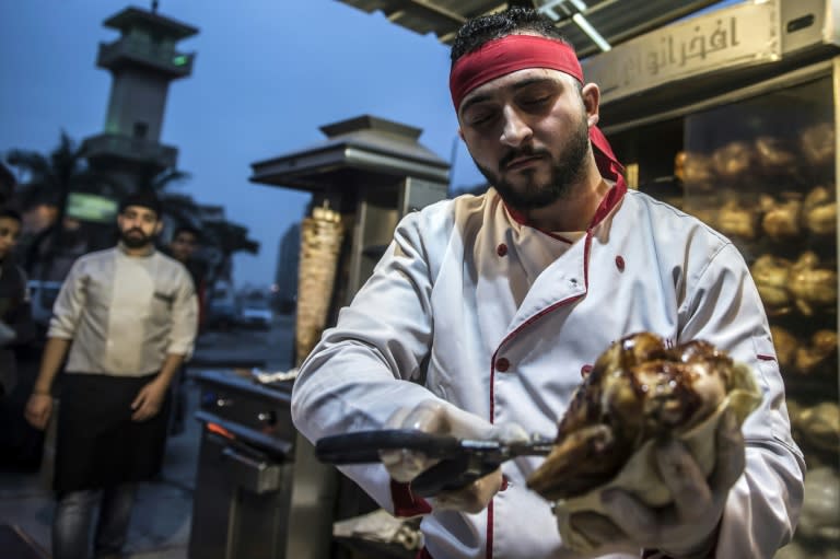 Syrian refugee Adel Bezmawy, co-founder of the sports academy in Egypt's Alexandria, Syrian Talented Academy, works at a restaurant in the coastal city on January 4, 2018