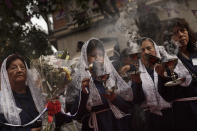 <p>A woman in a procession honoring the Lord of Miracles or “el Señor de los Milagros” in Madrid, Oct. 25, 2015. (Photo: Daniel Ochoa de Olza/AP) </p>