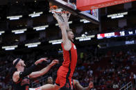 Houston Rockets center Jock Landale, top, dunks in front of Chicago Bulls guard Alex Caruso, left, during the first half of an NBA basketball game Thursday, March 21, 2024, in Houston. (AP Photo/Michael Wyke)