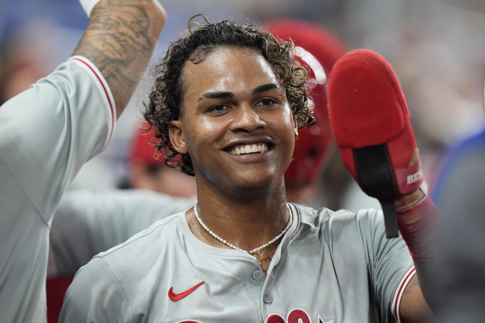Philadelphia Phillies' Cristian Pache is congratulated by teammates after he and Edmundo Sosa scored on a single by Kyle Schwarber during the fourth inning of a baseball game against the Miami Marlins, Friday, May 10, 2024, in Miami. (AP Photo/Wilfredo Lee)