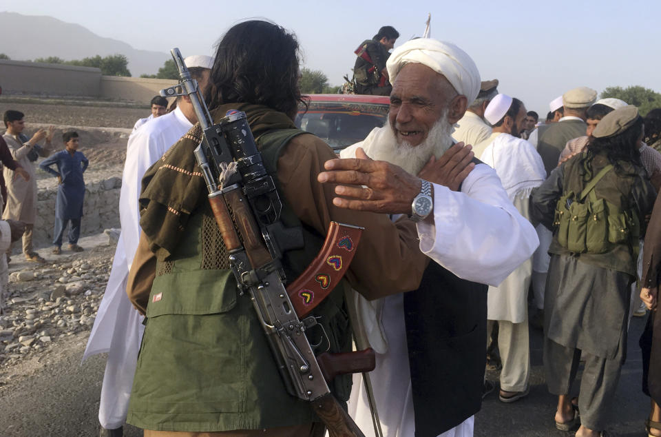 FILE - In this June 16, 2018, file photo, Taliban fighters gather with residents to celebrate a three-day cease fire marking the Islamic holiday of Eid al-Fitr, in Nangarhar province, east of Kabul, Afghanistan. In a rare diplomatic foray and the strongest sign yet of the Taliban's increasing political presence in the region, the head of the militant group's political office led a delegation to Uzbekistan to meet senior Foreign Ministry officials, Uzbek and Taliban officials said Saturday, Aug. 11, 2018. (AP Photo/Rahmat Gal, File)