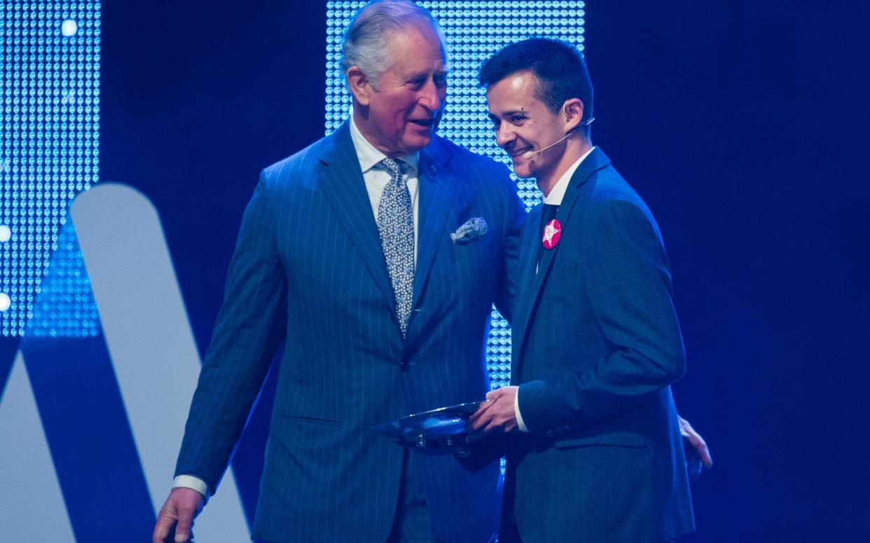 Dylan England, 26, receiving the award at the London Palladium on Wednesday - PA