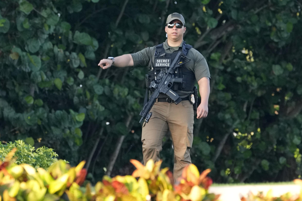 A Secret Service agent patrols on the property of former President Donald Trump's Mar-a-Lago estate, Sunday, April 2, 2023, in Palm Beach, Fla. Trump was indicted by a Manhattan grand jury Thursday. (AP Photo/Lynne Sladky)