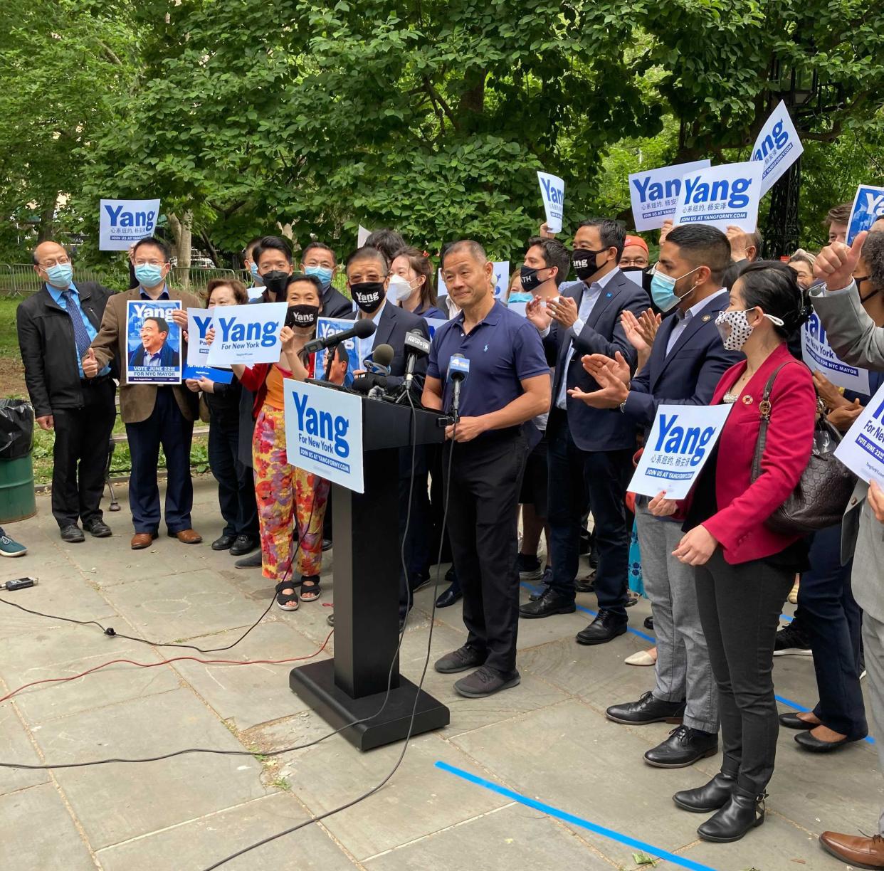 New York State Sen. John Liu (D-Queen) at the podium (center) and New York City mayoral candidate Andrew Yang standing behind Liu