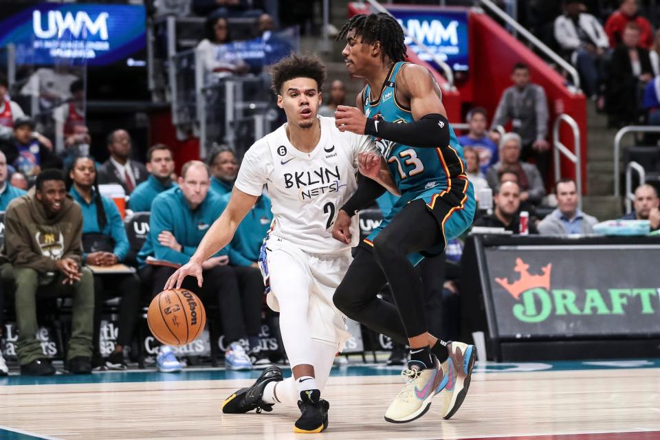 Brooklyn Nets forward Cameron Johnson (2) dribbles against Detroit Pistons guard Jaden Ivey (23) during the second half at Little Caesars Arena in Detroit on Wednesday,  April 5, 2023.