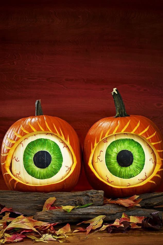 <p>Opt for a creepy statement by placing white pumpkins inside bigger orange pumpkins to resemble eyeballs. Stick two pumpkin creations side by side for extra impact. </p>