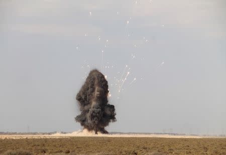 Smoke rises as Libyan forces dispose of explosives left behind by Islamic State militants following a battle in Sirte, at Misrata, Libya. REUTERS/Stringer