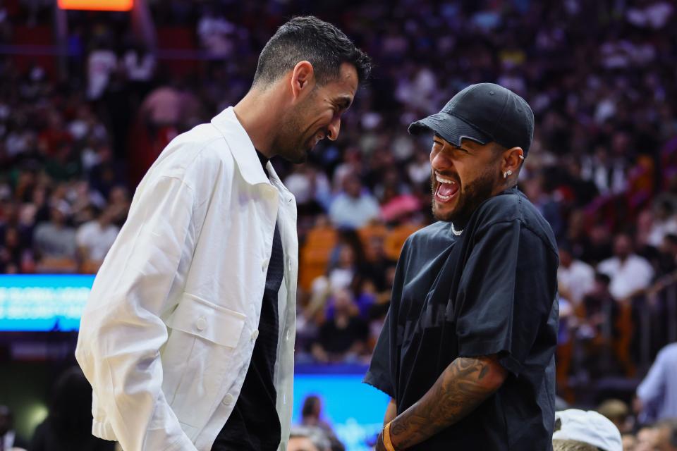 Inter Miami CF midfielder Sergio Busquets (left) and Brazilian soccer player Neymar Jr. attend the game between the Miami Heat and the Golden State Warriors at Kaseya Center.