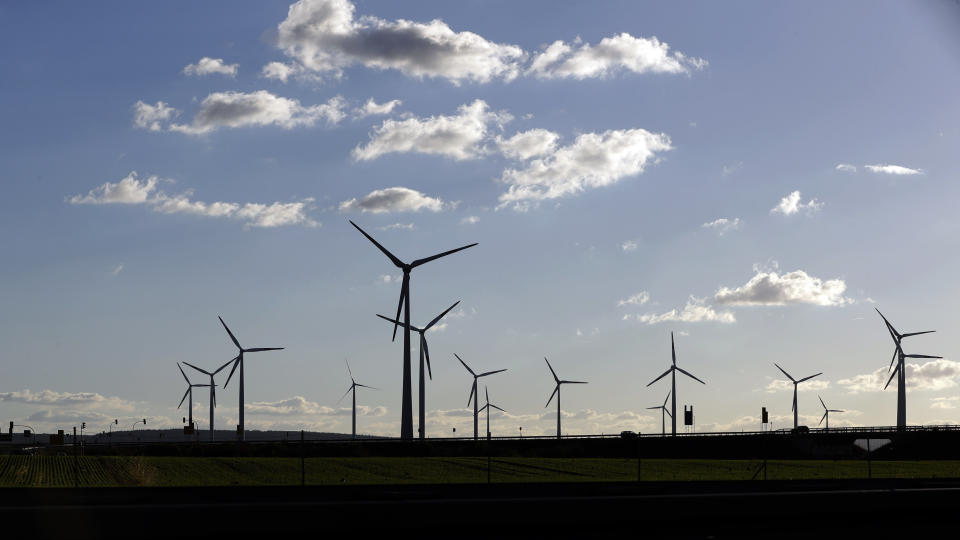 FILE-In this Oct. 4, 2016 taken photo wind turbines spin near Halle, central Germany. Germany’s top court has ruled that the government has to set clear goals for reducing greenhouse gas emissions after 2030, arguing that current legislation doesn’t go far enough in curbing climate change. (AP Photo/Matthias Schrader)