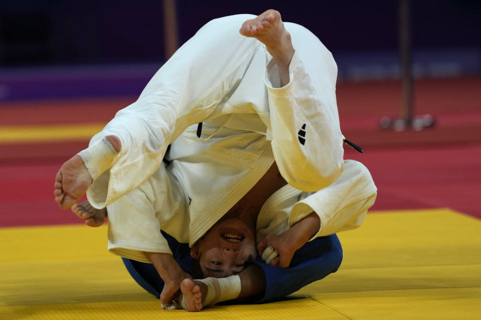 South Korea's Lee Harim in white fights with Taiwan's Yang Yung Wei in the Men's -60Kg Judo gold medal match for the 19th Asian Games in Hangzhou, China, Sunday, Sept. 24, 2023. (AP Photo/Ng Han Guan)