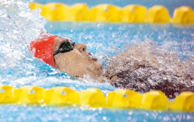 Kylie Masse of LaSalle, Ont., races to a national record at the Canadian Olympic swim trials in the women’s 100m backstroke in Toronto on Saturday.  (Frank Gunn/The Canadian Press  - image credit)