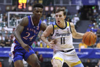 Marquette guard Tyler Kolek (11) tries to get around Kansas forward K.J. Adams Jr. (24) during the first half of an NCAA college basketball game Tuesday, Nov. 21, 2023, in Honolulu. (AP Photo/Marco Garcia)