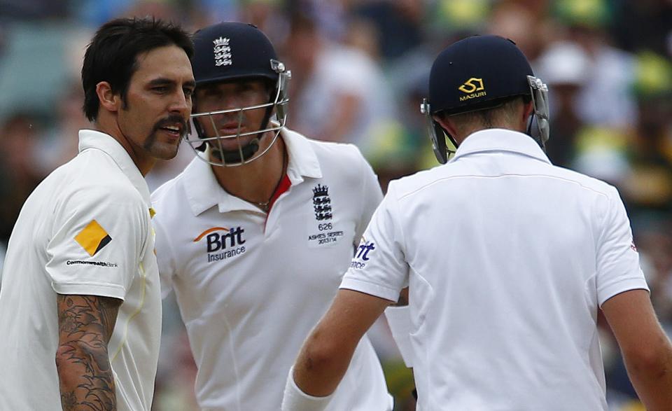 Australia's Mitchell Johnson (L) speaks to England's Joe Root (R) as Kevin Pietersen looks at them during the fourth day's play in the second Ashes cricket test at the Adelaide Oval December 8, 2013.