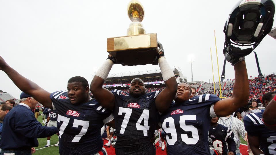 Michael Oher hoists the Golden Egg trophy with teammates after Ole Miss beat Mississippi State on November 28, 2008, in Oxford, Mississippi. - Matthew Sharpe/Getty Images