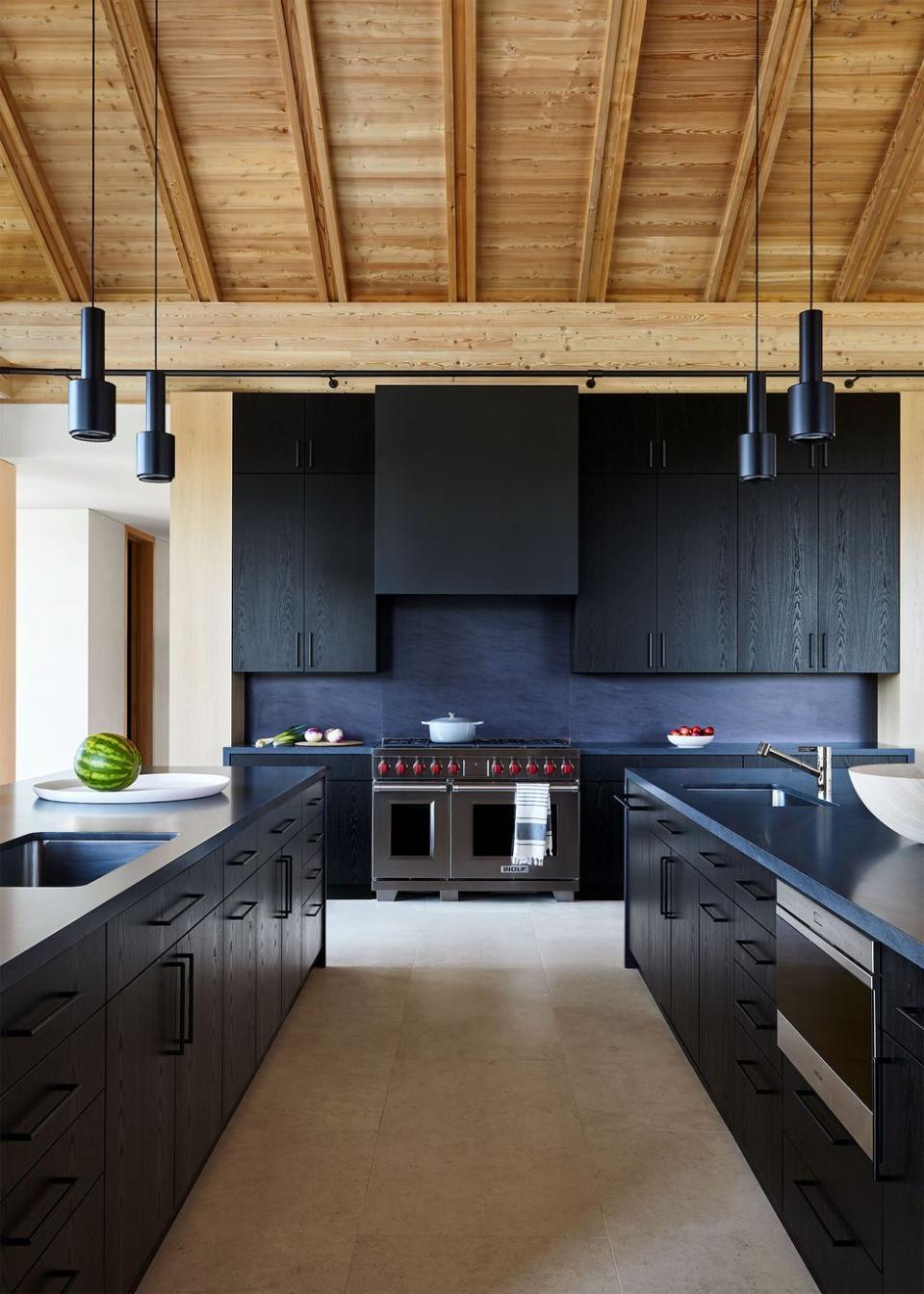 a kitchen with black cabinets