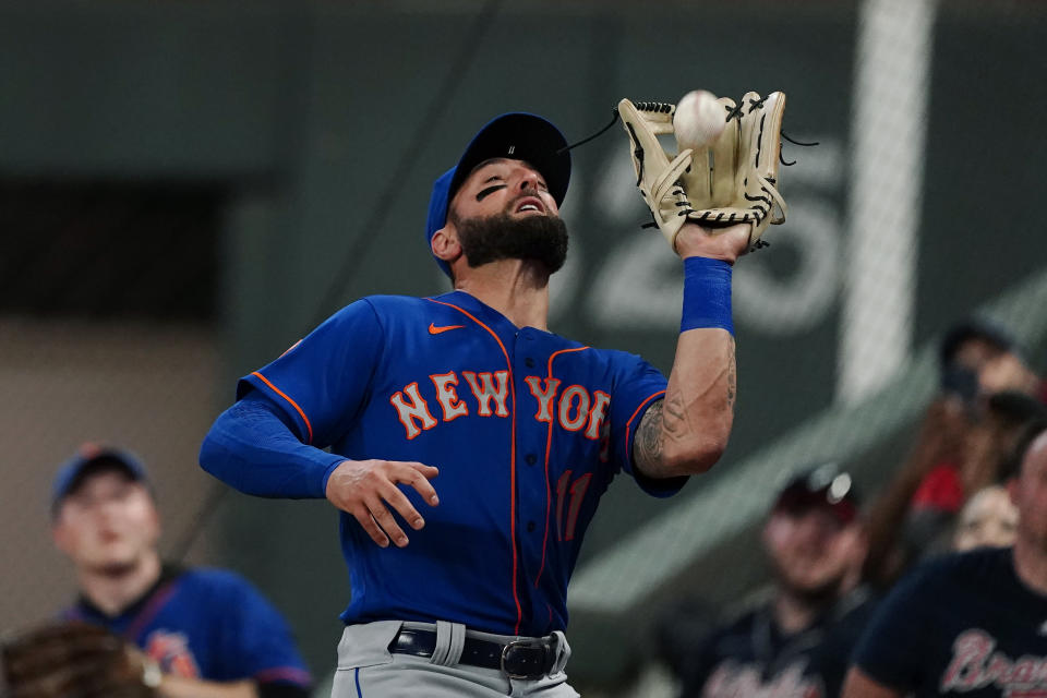 New York Mets right fielder Kevin Pillar (11) catches a ball in foul territory to retire Atlanta Braves' Ronald Acuna Jr. in the sixth inning of a baseball game Monday, May 17, 2021, in Atlanta. (AP Photo/John Bazemore)