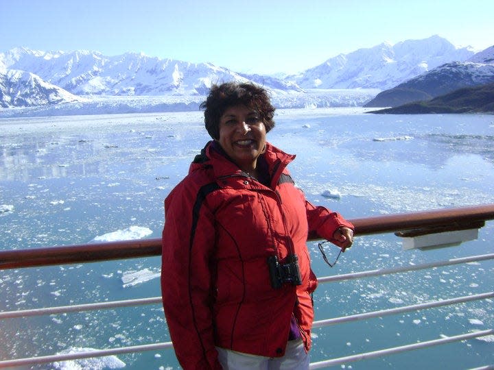 Nargis Kheraj, from New Brunswick, Canada, is an avid cruiser. Here, she poses in front of Hubbard Glacier in Alaska in June 2010.