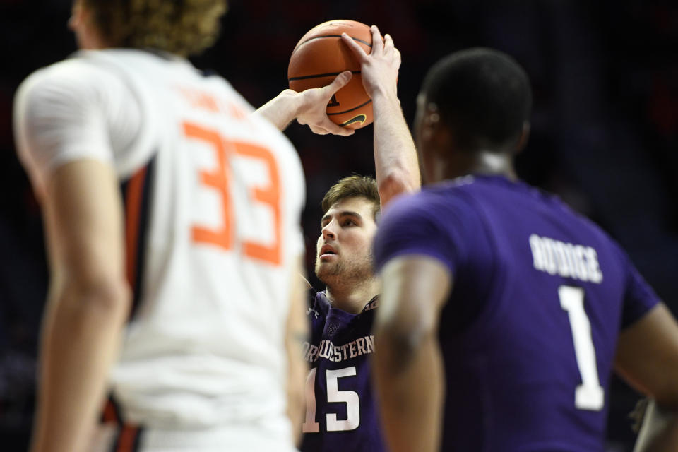 Northwestern's Ryan Young shoots a free throw during the second half of an NCAA college basketball game against Illinois, Sunday, Feb. 13, 2022, in Champaign, Ill. (AP Photo/Michael Allio)
