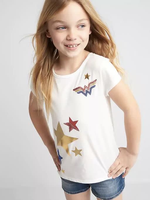 $24, <a href="http://www.gap.com/browse/product.do?pid=733292012&amp;vid=1&amp;locale=en_US&amp;kwid=1&amp;sem=false&amp;sdkw=gapkids-124-wonder-woman-strap-back-tee-P733292&amp;sdReferer=http%3A%2F%2Fwww.gap.com%2Fproducts%2Fgap-x-wonder-woman-collection-C1072174.jsp" target="_blank">here</a>