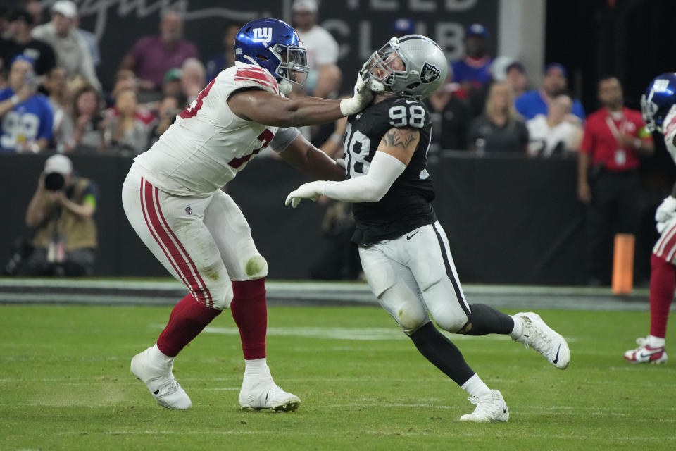 New York Giants offensive tackle Evan Neal (73) battles Las Vegas Raiders defensive end Maxx Crosby (98) during the second half of an NFL football game, Sunday, Nov. 5, 2023, in Las Vegas. (AP Photo/Rick Scuteri)