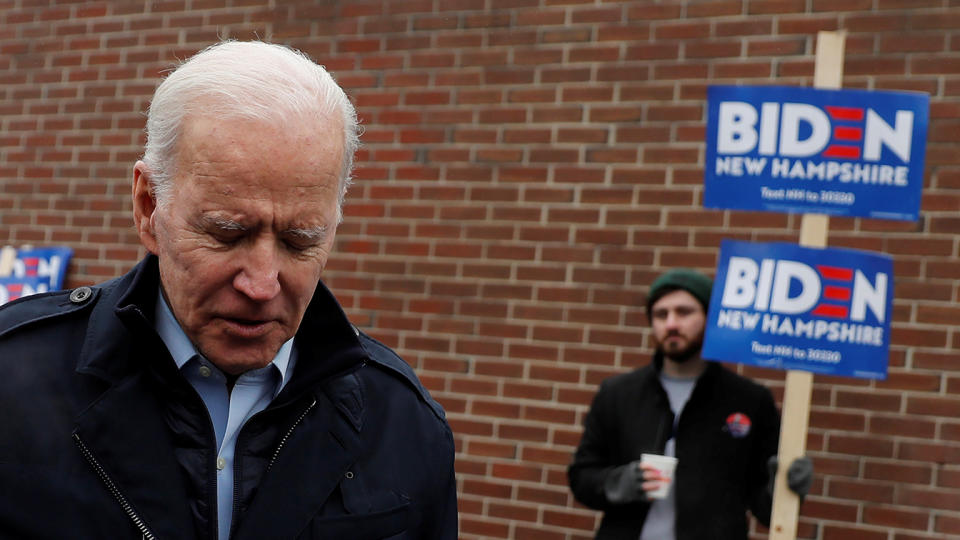 A supporter for Democratic 2020 U.S. presidential candidate and former Vice President Joe Biden holds a sign as Biden leaves a polling station in Manchester, New Hampshire on February 11, 2020. (Carlos Barria/Reuters)