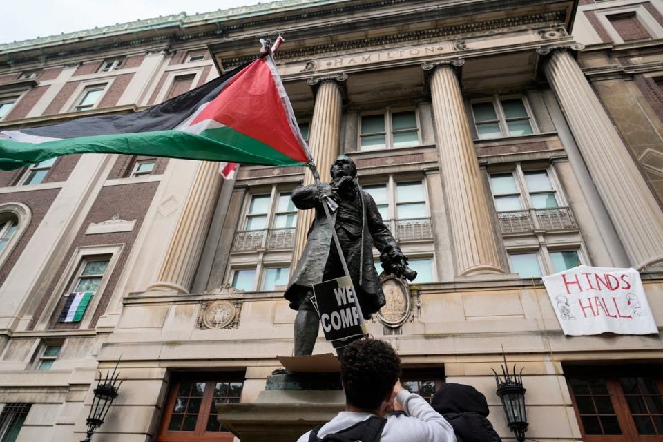 A student protester parades a Palestinian flag outside the entrance to Hamilton Hall. Pro-Palestinian protesters occupied the building on Columbia University’s campus early Tuesday morning (Getty Images)